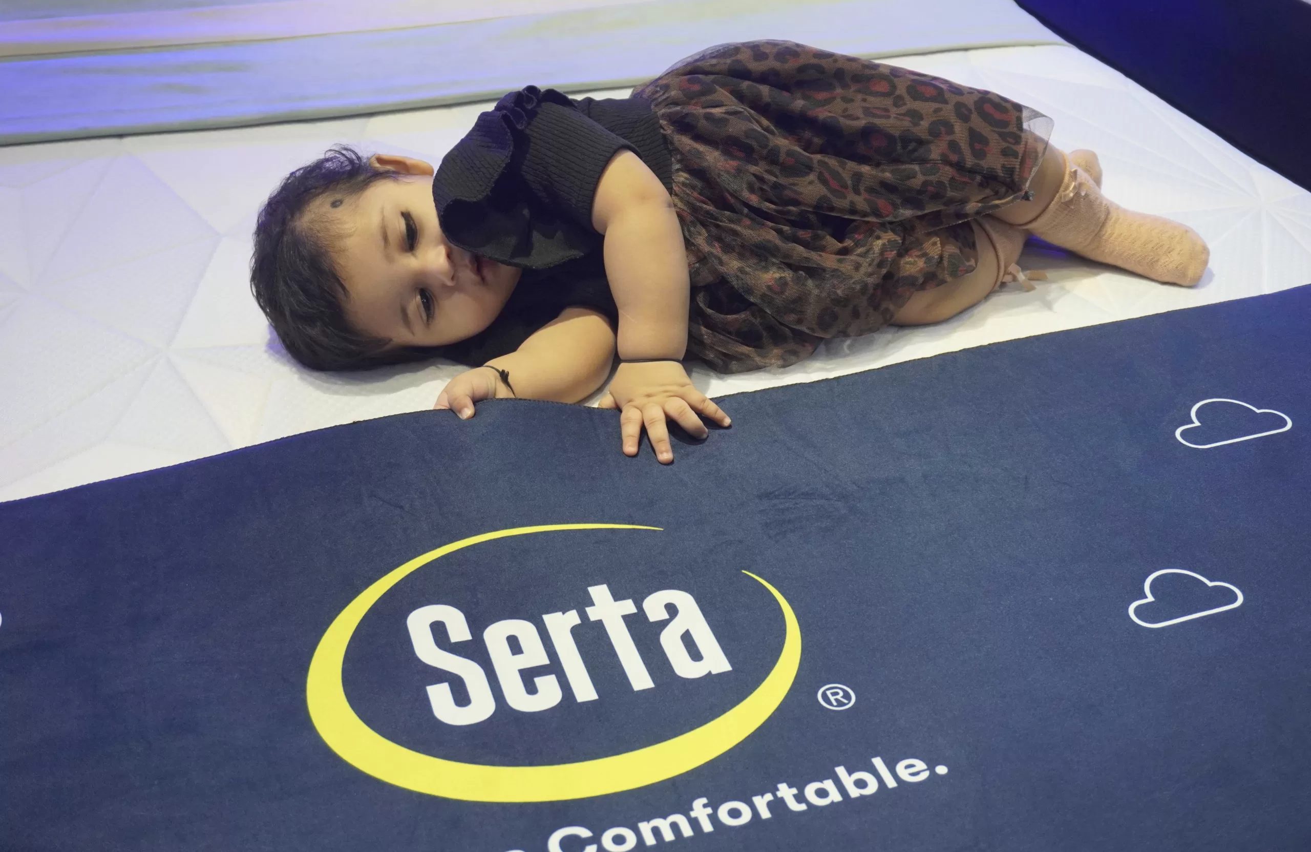 SEEN A TODDLER TAKING A SOUND SLEEP ON SERTA MATTRESS DURING THE INAUGURAITON OF THE SHOWROOM