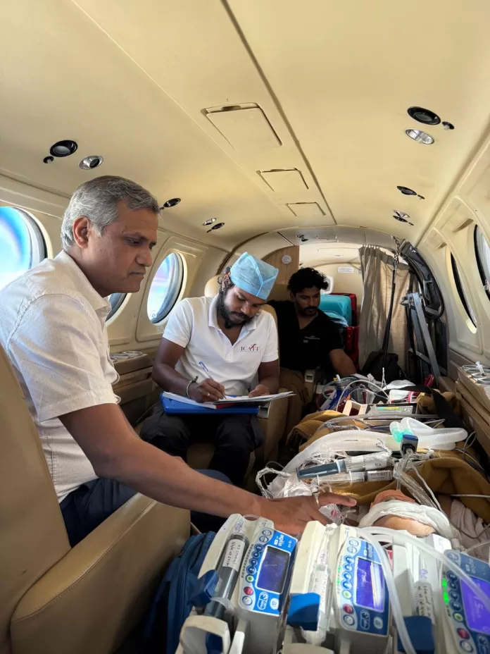 ECMO A specialized medical team monitoring a critically ill pediatric patient connected to ECMO life-support equipment inside an air ambulance.